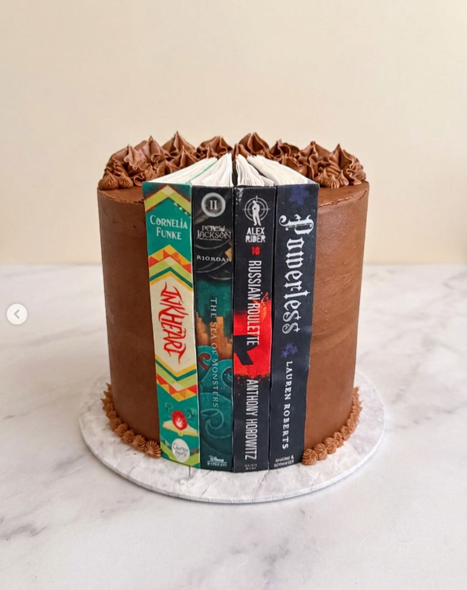 Chocolate book stack cake featuring favourite novel spines