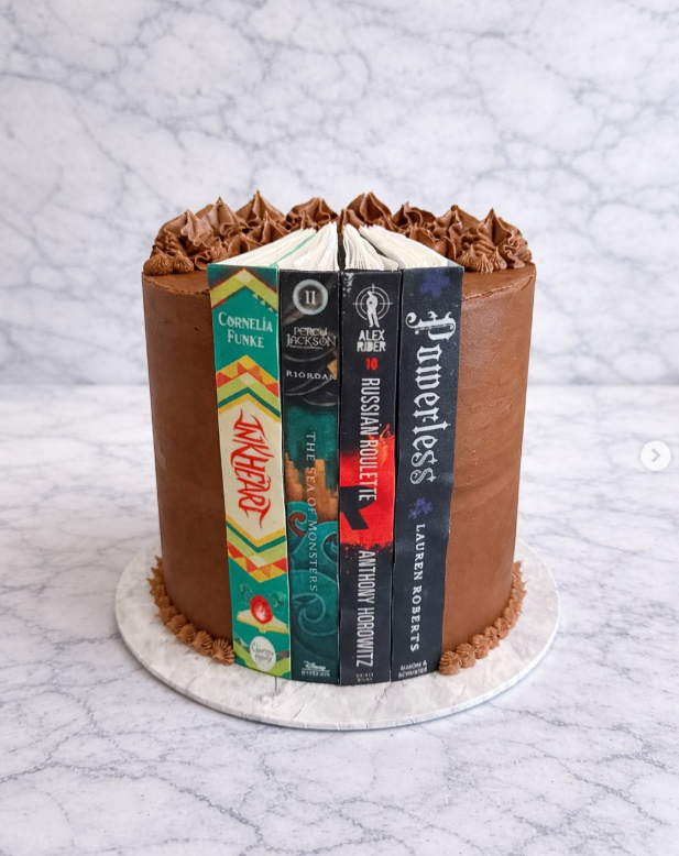 Chocolate book stack cake featuring favourite novel spines