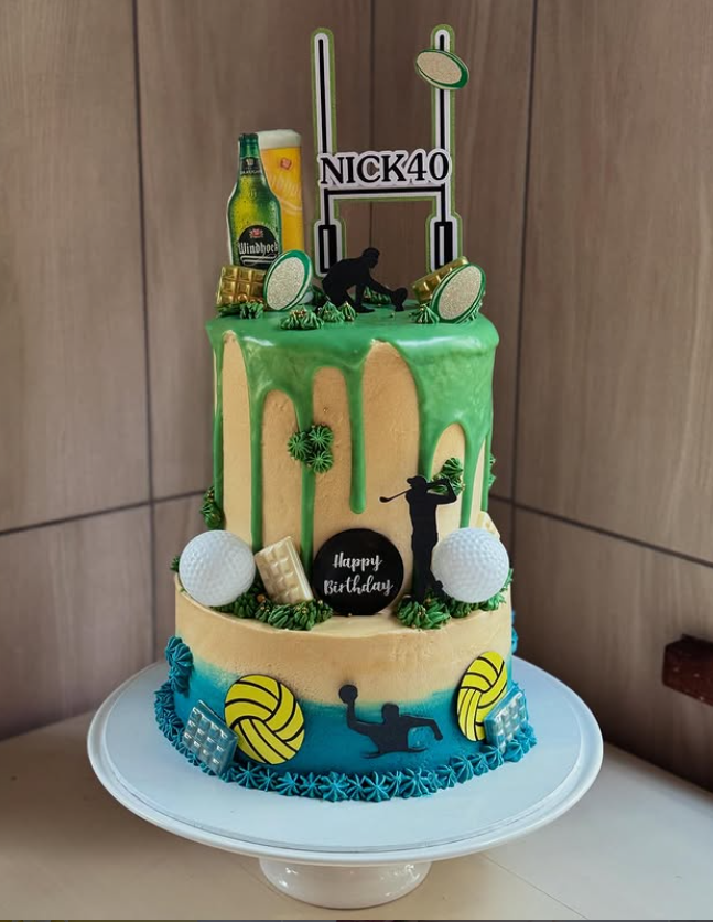 Two-tier NICK40 sports themed cake with rugby, golf and water polo
