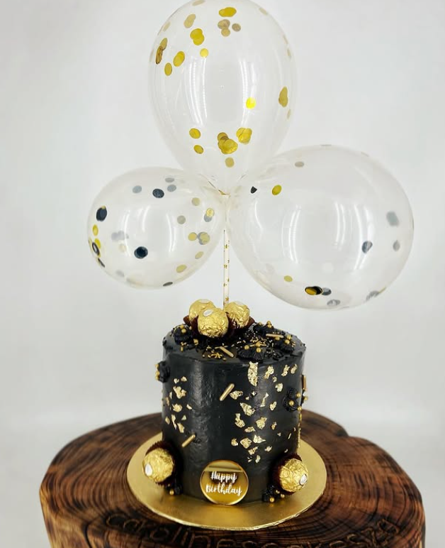 Black 40th cake with gold leaf, Ferrero Rocher and confetti balloons