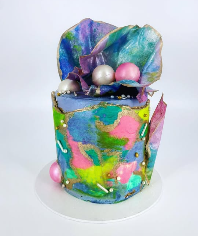 Hand painted watercolour buttercream cake with wafer paper sails and pearls